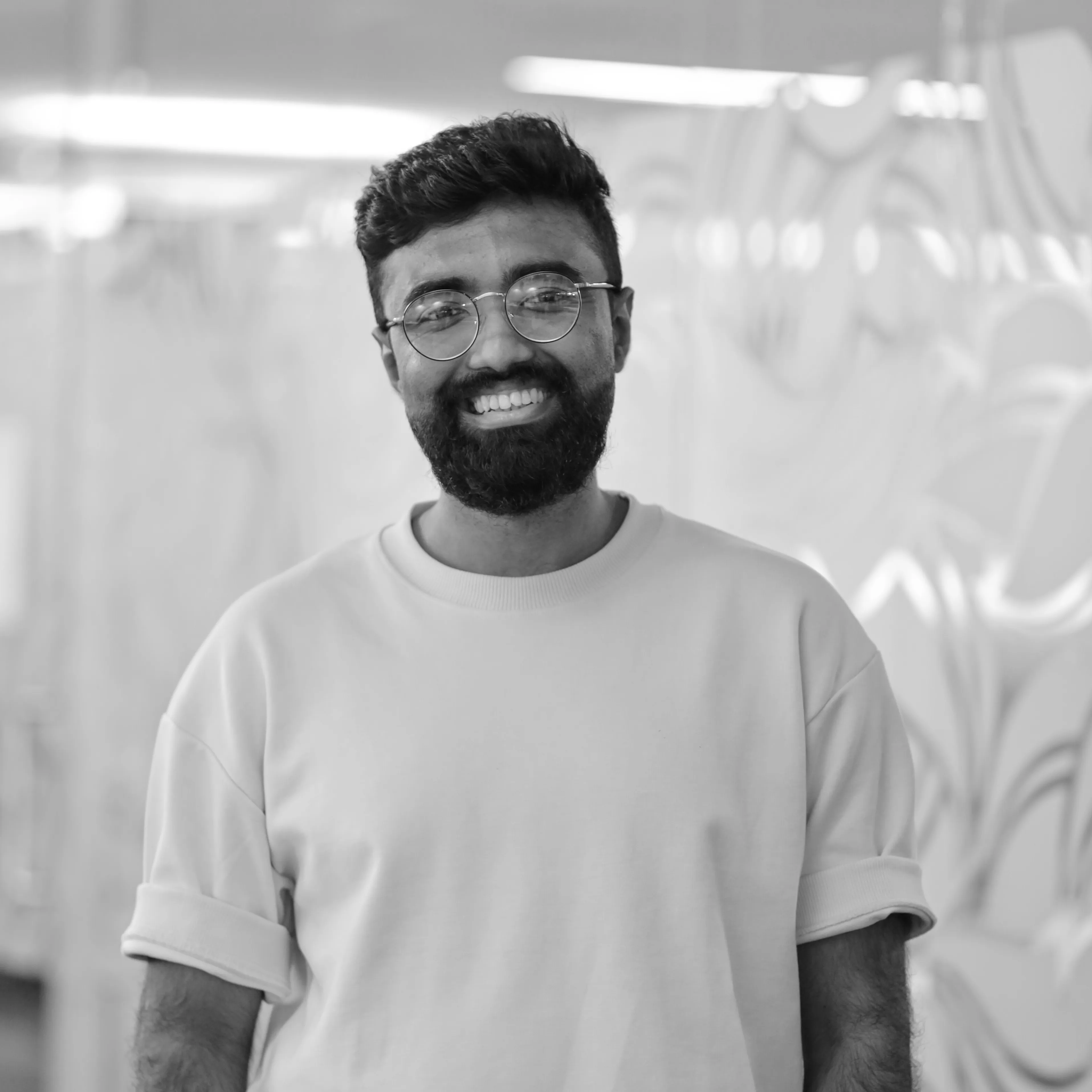 Tousif Rahaman, smiling and wearing glasses